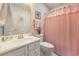 Bright bathroom with a white sink, toilet, and pink shower curtain at 3986 Lochview Dr., Myrtle Beach, SC 29588