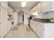 Functional kitchen featuring white cabinetry, tile flooring, and modern appliances at 3986 Lochview Dr., Myrtle Beach, SC 29588