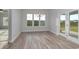 Bright dining room featuring wood-look floors and a view of the landscaped yard at 4036 Bucolic Loop, Myrtle Beach, SC 29588