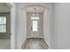 Inviting entryway featuring stylish wood floors, an arched doorway, and a modern chandelier at 4036 Bucolic Loop, Myrtle Beach, SC 29588