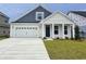 Charming two-story home with a manicured lawn and attached two-car garage, showcasing modern design at 4036 Bucolic Loop, Myrtle Beach, SC 29588