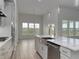 An open concept kitchen that features stainless steel appliances, an island, and natural light at 4036 Bucolic Loop, Myrtle Beach, SC 29588