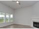 Bright living room with a fireplace, ceiling fan, and views of the backyard at 4036 Bucolic Loop, Myrtle Beach, SC 29588