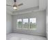 Main bedroom with tray ceiling, ceiling fan, and triple windows offering scenic views at 4036 Bucolic Loop, Myrtle Beach, SC 29588