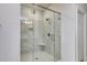 Modern glass-enclosed shower with marble tile, built-in niche, and rainfall showerhead at 4036 Bucolic Loop, Myrtle Beach, SC 29588