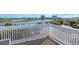 Scenic waterfront view from a spacious deck with white railing, ideal for relaxation and enjoying the surroundings at 409 36Th Ave. N, North Myrtle Beach, SC 29582