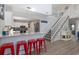 Stylish kitchen featuring barstool seating and views of the staircase, perfect for casual dining and entertaining guests at 409 36Th Ave. N, North Myrtle Beach, SC 29582