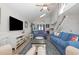 Open-concept living room with a large TV, nautical decor, and a seamless flow to the kitchen, perfect for entertaining at 409 36Th Ave. N, North Myrtle Beach, SC 29582