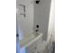 Bathroom showcases white tiled walls, dark shower head and fixtures, plus white marbled floors at 412 Olive St., Georgetown, SC 29440