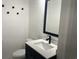 Stylish half bathroom featuring a modern vanity with a white countertop and a sleek black faucet at 412 Olive St., Georgetown, SC 29440