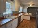 Well-lit kitchen featuring white cabinetry, updated countertops, stainless steel appliances, and hardwood floors at 412 Olive St., Georgetown, SC 29440