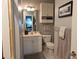 Bathroom with a single sink, light grey wall paint, a decorative mirror, and a white toilet at 4221 Hibiscus Dr. # 101, Little River, SC 29566