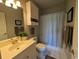 Bathroom with a single sink, light grey wall paint, a decorative mirror, and a white toilet at 4221 Hibiscus Dr. # 101, Little River, SC 29566