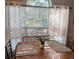 Well-lit dining area with a round wooden table and bright window creates a cozy and inviting space at 4221 Hibiscus Dr. # 101, Little River, SC 29566