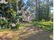 Multi-Gathering unit with green grass and magnolia tree at 4221 Hibiscus Dr. # 101, Little River, SC 29566