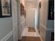 Well-lit hallway with neutral paint, white trim, and tiled floors offers a clean and inviting entry at 4221 Hibiscus Dr. # 101, Little River, SC 29566