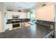 Bright kitchen with white cabinets, black countertops, stainless steel appliances, and backsplash detail at 4221 Hibiscus Dr. # 101, Little River, SC 29566