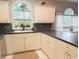 Bright kitchen with white cabinets, black countertops, stainless steel appliances, and backsplash detail at 4221 Hibiscus Dr. # 101, Little River, SC 29566