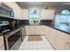 Bright kitchen with white cabinets, black countertops, stainless steel appliances, and backsplash detail at 4221 Hibiscus Dr. # 101, Little River, SC 29566