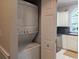 A laundry closet with a stacked washer and dryer set, next to the kitchen at 4221 Hibiscus Dr. # 101, Little River, SC 29566