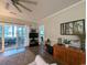 Spacious living room with sliding doors to a sunroom, laminate floors, and tasteful decor for modern living at 4221 Hibiscus Dr. # 101, Little River, SC 29566
