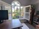 Bright office space with large window, plantation shutters, and custom bookshelf provides inspiring views and organization at 4221 Hibiscus Dr. # 101, Little River, SC 29566