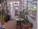 Bright sunroom with many windows, indoor plants, and decorative stained glass offers a peaceful retreat at 4221 Hibiscus Dr. # 101, Little River, SC 29566