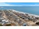Aerial view of a coastal community with beach access and clear blue ocean views at 436 E Third St., Ocean Isle Beach, NC 28469