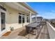 Spacious back porch with string lights, an outdoor dining table, and a peek of the ocean in the distance at 436 E Third St., Ocean Isle Beach, NC 28469
