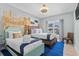 Beach themed bedroom with two beds, wood accents, and a coastal design at 436 E Third St., Ocean Isle Beach, NC 28469