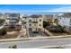 Charming three-story yellow beach home with dual balconies and neighborhood ocean views at 436 E Third St., Ocean Isle Beach, NC 28469