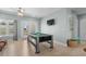 Game room with a pool table, entertainment setup, and access to outdoor views at 436 E Third St., Ocean Isle Beach, NC 28469