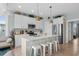 Bright kitchen with white cabinetry, a central island with seating, and stainless steel appliances for modern convenience at 436 E Third St., Ocean Isle Beach, NC 28469