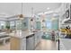 Island kitchen with pendant lighting and seating area with a view at 436 E Third St., Ocean Isle Beach, NC 28469