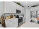 Stylish kitchen with white cabinets, stainless steel appliances, and a spacious countertop, great for culinary enthusiasts at 436 E Third St., Ocean Isle Beach, NC 28469