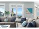 Cozy living room with ocean views from large windows, comfortable sofas, and beach-themed decor at 436 E Third St., Ocean Isle Beach, NC 28469