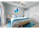 Bright main bedroom featuring a king bed, tray ceiling, a bench, and access to a balcony at 436 E Third St., Ocean Isle Beach, NC 28469