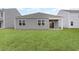 A spacious backyard featuring well-maintained grass and a covered patio area at 4517 East Coast Ln., Shallotte, NC 28470