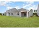 A well-manicured backyard with an extended patio, perfect for outdoor relaxation at 4517 East Coast Ln., Shallotte, NC 28470