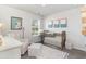 Charming Bedroom with a crib, accent chair, and playful decor at 4517 East Coast Ln., Shallotte, NC 28470