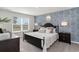 Comfortable bedroom featuring a decorative wall, plush bedding, and ample natural light at 4517 East Coast Ln., Shallotte, NC 28470