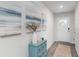 Inviting entryway showcases stylish decor and a bright white front door, complemented by wood-look flooring and neutral walls at 4517 East Coast Ln., Shallotte, NC 28470