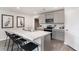 Bright kitchen with a center island, stainless steel appliances, gray cabinetry, and modern decor elements at 4517 East Coast Ln., Shallotte, NC 28470
