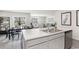 Open-concept kitchen and dining area, featuring an island with seating and a view into the living space at 4517 East Coast Ln., Shallotte, NC 28470