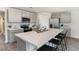 Well-equipped kitchen with an island featuring bar seating, stainless steel appliances, and ample counter space at 4517 East Coast Ln., Shallotte, NC 28470