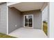 Covered patio with sliding glass doors and a concrete floor, perfect for outdoor living at 4517 East Coast Ln., Shallotte, NC 28470