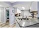 Compact kitchen with granite countertops, white cabinets, and modern appliances at 4601 N Ocean Blvd. # 201, North Myrtle Beach, SC 29582
