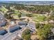 An aerial view of the community featuring a golf course, lake, and mature trees at 4787 Wild Iris Dr. # 203, Myrtle Beach, SC 29577