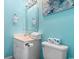Modern bathroom with bright blue walls, a white vanity, and well-organized amenities at 4787 Wild Iris Dr. # 203, Myrtle Beach, SC 29577