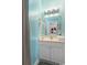 Bright bathroom with light blue walls, a white vanity, and a well-lit mirror at 4787 Wild Iris Dr. # 203, Myrtle Beach, SC 29577